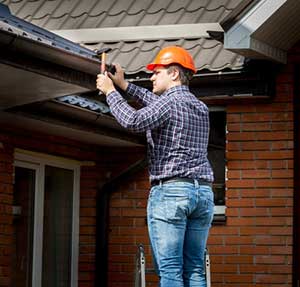 Northern Virginia roof repair contractor performing regular maintenance on roof