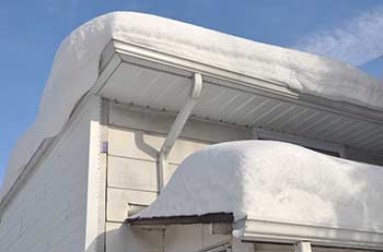Too much snow on roofing causing potential roof repair services