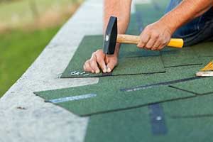 Roofing contractor performing roof repairs to help make roof last forever