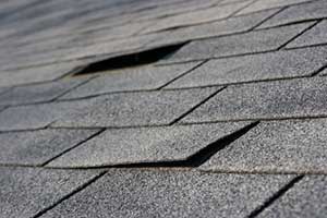 Splitting shingles indicating the need for a roof leak repair service