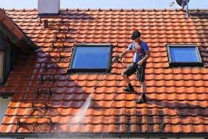 Roof repair contractor cleaning roof
