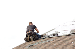 an Arlington, VA roof repair contractor working on servicing a roof