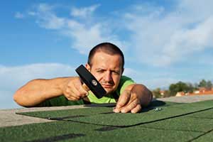 Northern VA roofing contractor installing shingles during a Lowes Island, VA roof repair