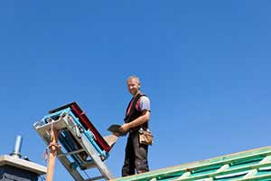 Northern Virginia roofing contractor on top of roof during a Reston, VA roof repair