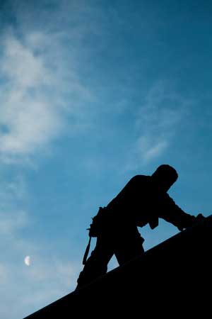 Quality roofing contractor working on roof