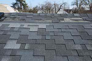 Roof showing inadequate roofing work performed by a scam roofing contractor