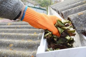 gutters that became clogged up next to a roof that needs emergency repairs due to flash flooding