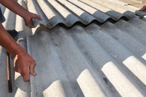 a roof repair contractor training a second contractor while repairing an old roof