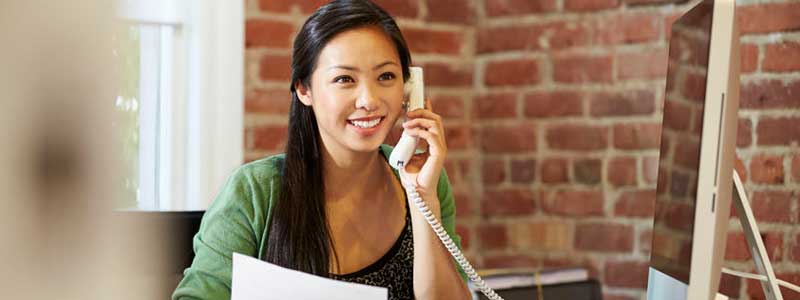 Sales assistant for Northern Virginia roofing company talking on phone