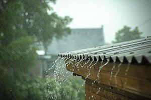 rain pouring down on a roof during a massive thunderstorm in Fairfax that has created roof damage as well as a roof leak