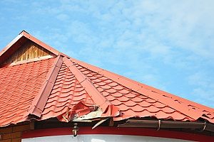 a Fairfax, VA roof that is very dented and crushed near the gutter system so it will need emergency roof tarping services in case a storm were to occur