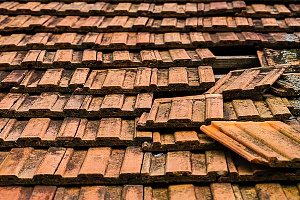 metal roof that has been damaged and needs significant repairs since the homeonwers were unaware of water collecting on top of the roof