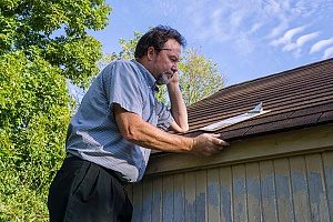 a homeowner conducting a total roof evaluation on his roof to make sure he is not in need of a roof repair or replacement