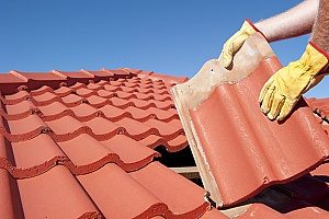 a roof shingle that is being replaced by roofing contractors since the homeowners wanted a metal roof