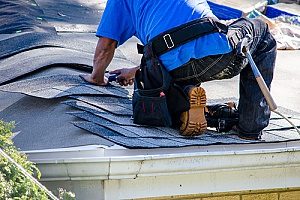 Fairfax, VA roof repair contractors fixing and repairing a roof that has been curved due to massive storms in the area during the summer