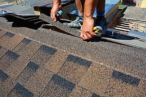 roof repair contractors in Fairfax, VA performing regularly scheduled roof maintenance for a family that has roof insurance