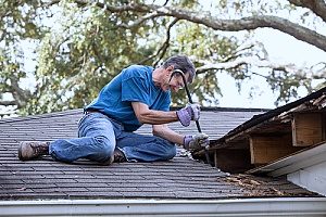 Northern Virginia roof maintenance being performed by a Fairfax, VA roofing contractor who has serviced the roof he is maintaining for over ten years