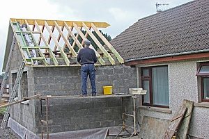 a man conducting a roof replacement that comes with a workmanship warranty