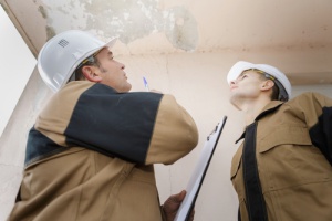 roof repair contractors inspecting an emergency roof leak