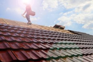 a roof replacement contractor working on the roof of a home