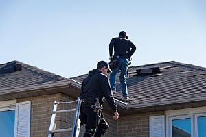 insurance inspectors looking over damaged roof