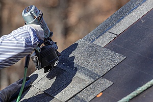 homeowner using new roof repair products to fix roof