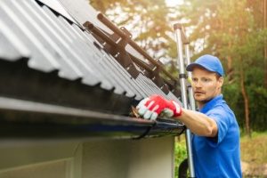 man cleaning a Gutter