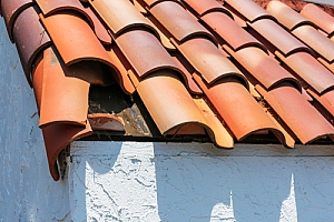 Clay tile roof with shingle broken and exposing rot