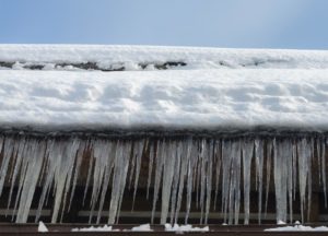 Icicles from ice dam hanging off roof