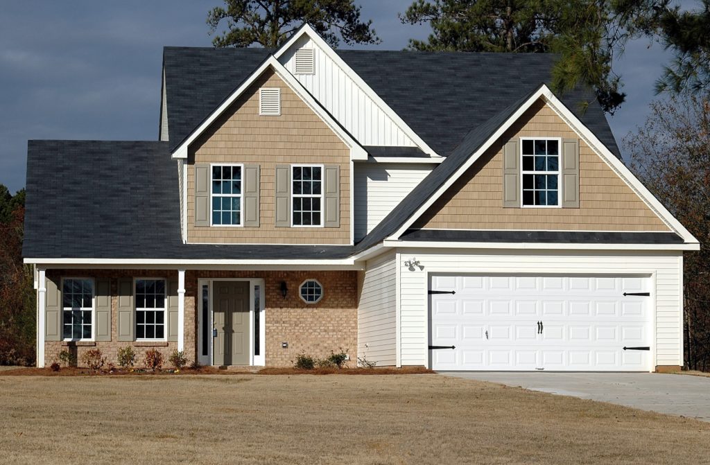 White and brown house with new siding installation from Beyond Exteriors, a trusted siding company in Northern VA.